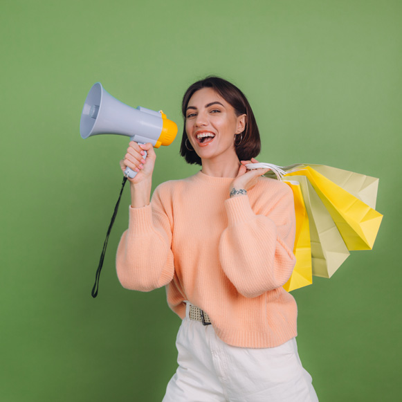 Woman holding shopping bags announces discounts