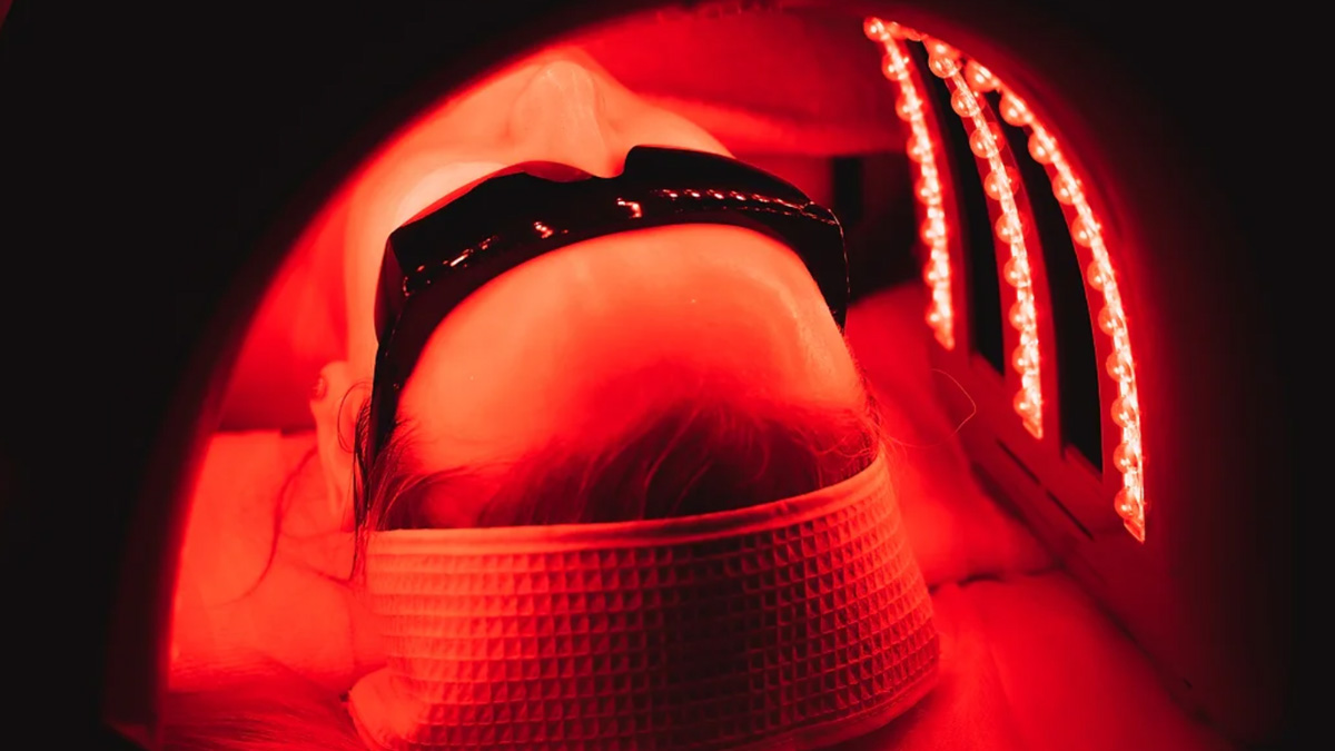 Woman under red LED light therapy