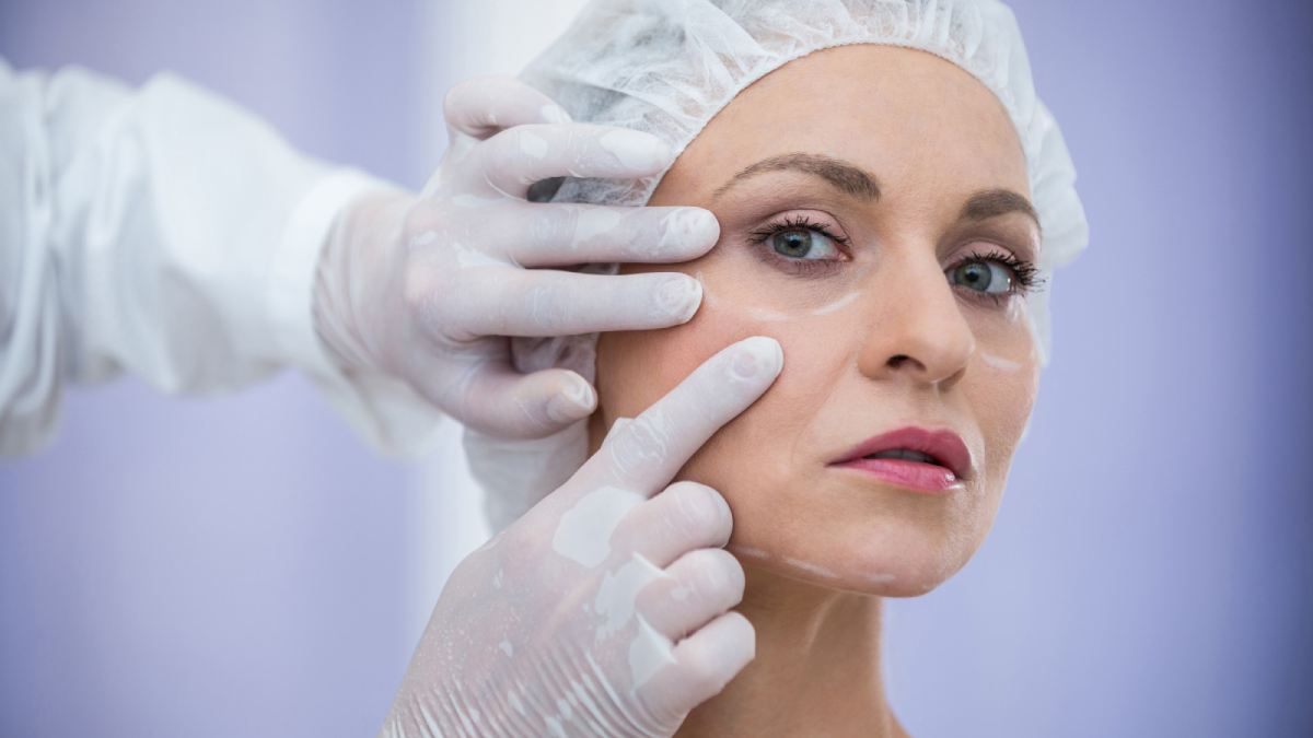Doctor examining woman-face fine lines and wrinkles